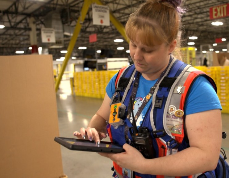 amazon's hand-held device in warehouse, source:https://blog.aboutamazon.com/operations/5-things-you-dont-know-about-safety-in-amazon-warehouses